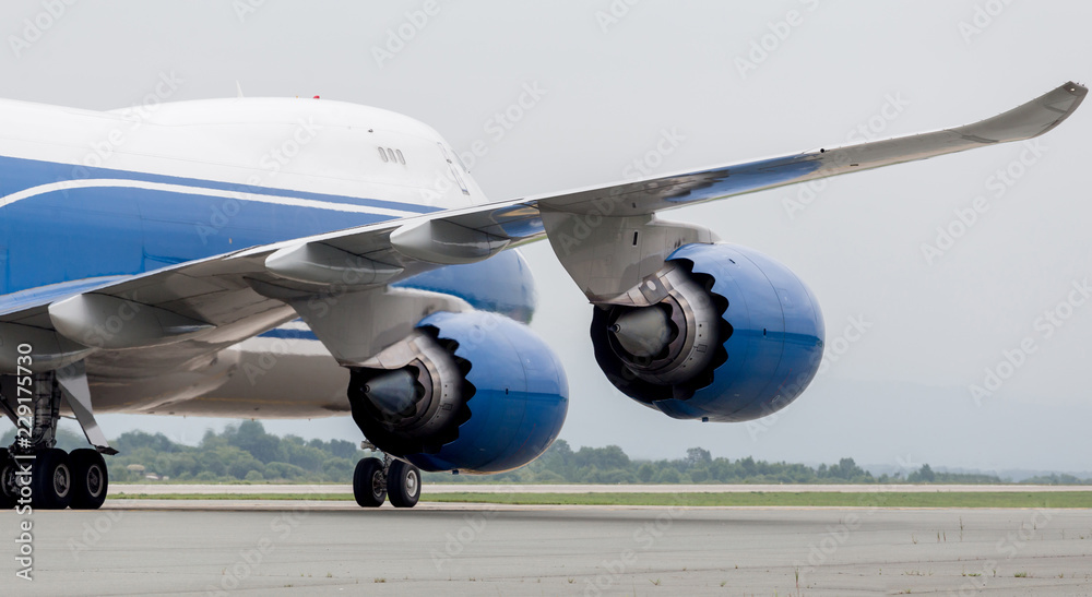 Fototapeta premium Engine and fuselage of modern jet cargo aircraft on a runway. Aviation and transportation.