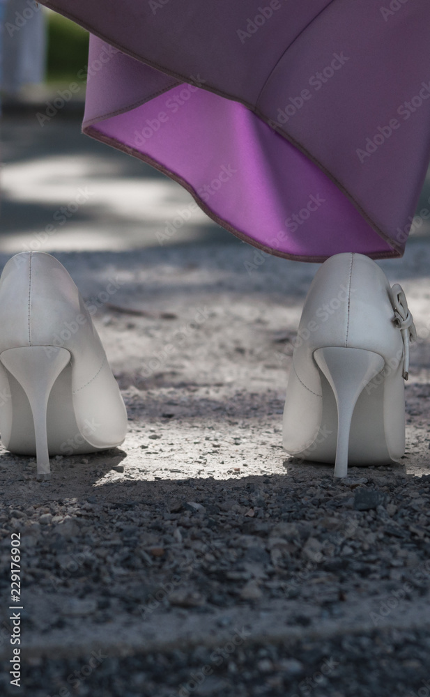 Bride's white shoes and lilac dress hem, close-up Stock Photo | Adobe Stock