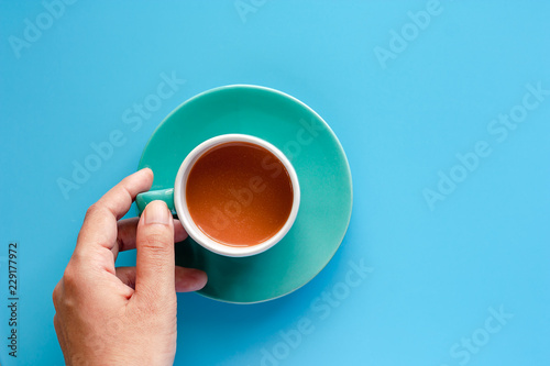 Hand holding cup of coffee ...