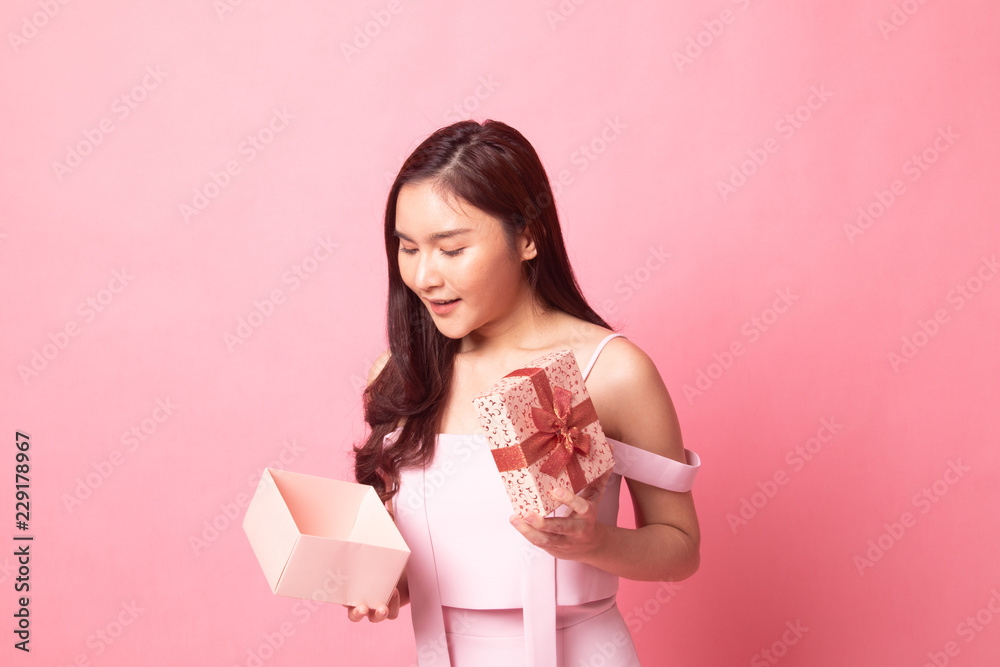 Young Asian woman open a gift box. Young Asian woman open a gift box.