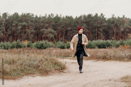 Wanderlust journey. Man traveler with binoculars in forest. Travel concept. Filtered image, cross processed vintage effect.