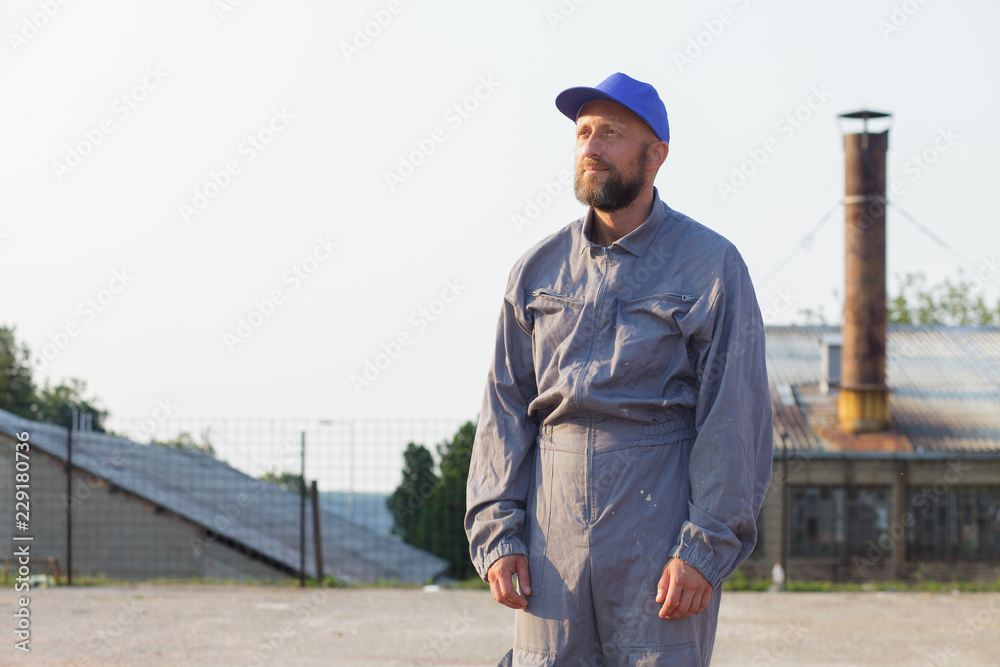 industrial manufacturing factory worker posing in front of the factory