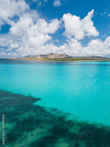 Beach landscape. Emerald green sea water and rocks on coast of Sardinia, Italy. © Spada Films