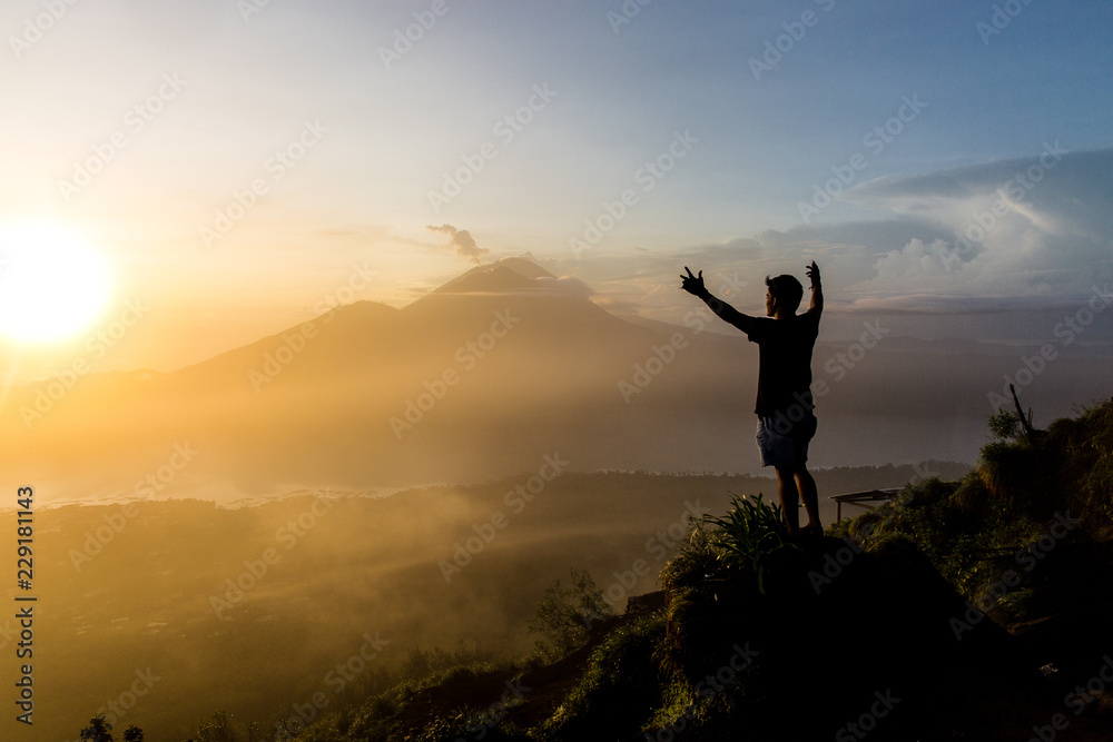 silhouette of man on top of mountain