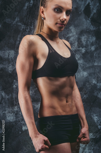 Muscular female on gray background