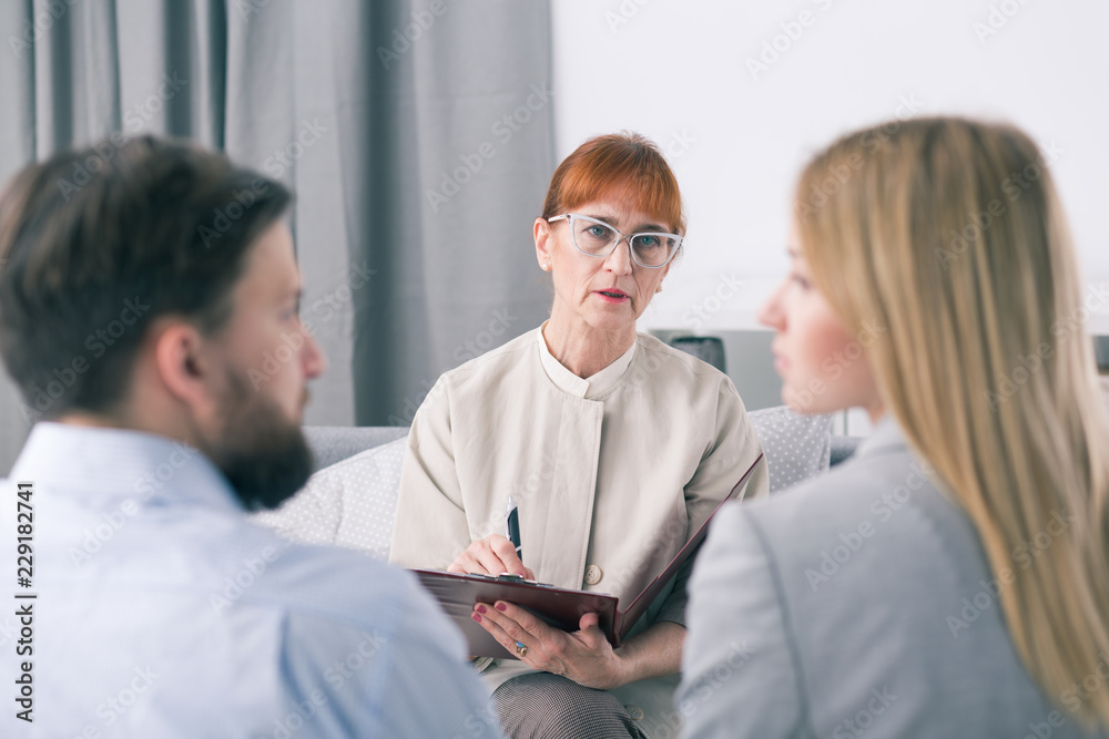 Mediator talking to a couple during a session Mediator talking to a couple during a session