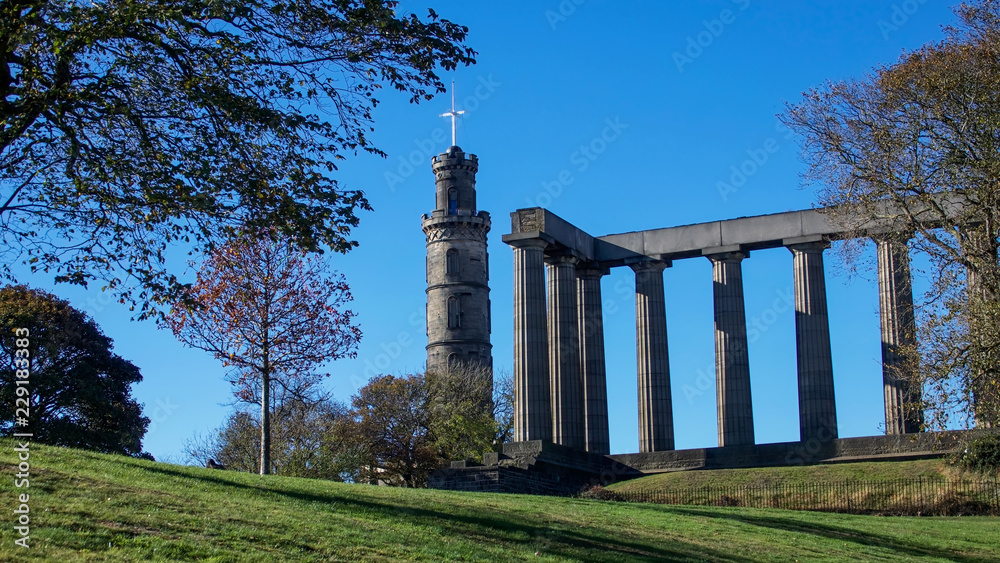 The National Monument and Nelson Monument on Calton Hill in Edinburgh on a bright autumn day.