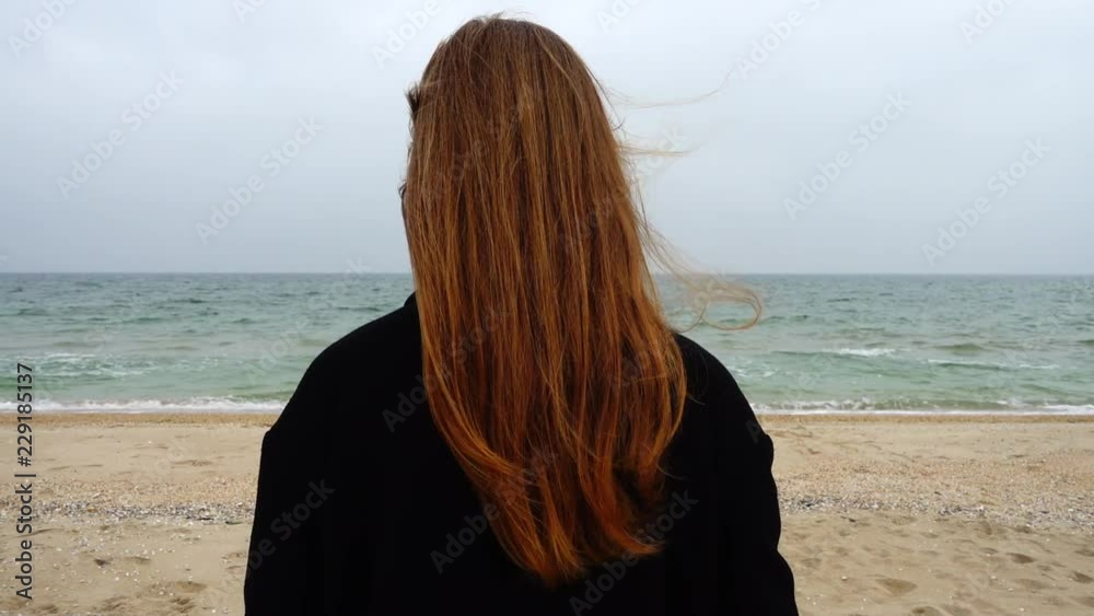The girl looks at the sea. Slow motion. Shooting on the beach. The girl looks at the sea. Slow motion. Shooting on the beach.