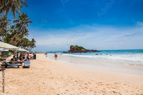 Tourists on  wonderful beach of Mirissa,  Sri Lanka.