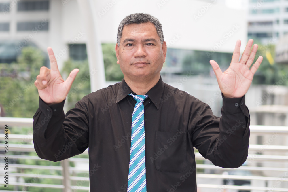 happy old man pointing up seven fingers; retired pensioner counting, numbering with finger point; senior old man points seven fingers up portrait; southeast old senior man model happy old man pointing up seven fingers; retired pensioner counting, numbering with finger point; senior old man points seven fingers up portrait; southeast old senior man model