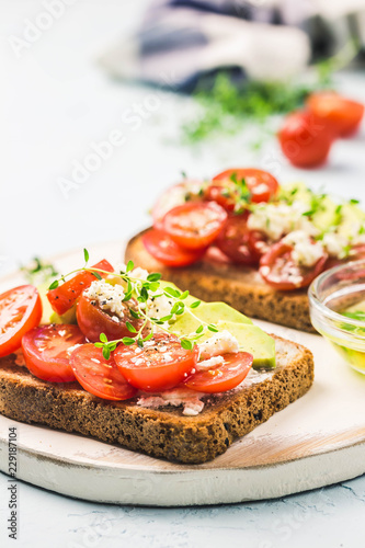 Avocado tomatoes goat cheese sandwiches. Selective focus  space for text.