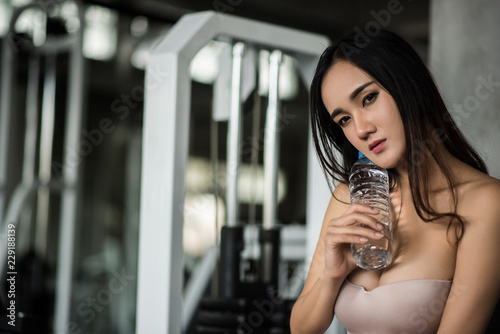 Sexy sporty woman with exercise equipment In the gym