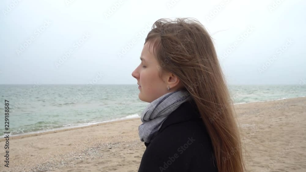 The girl looks at the sea. Slow motion. Shooting on the beach. The girl looks at the sea. Slow motion. Shooting on the beach.