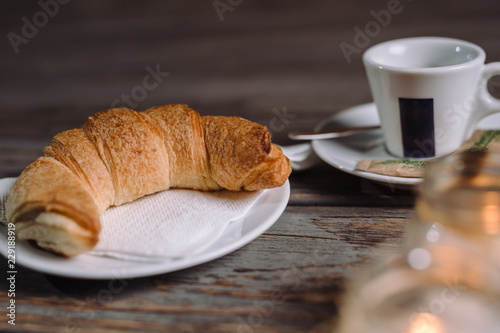 Fototapeta Naklejka Na Ścianę i Meble -  Croissant and coffee on wooden table