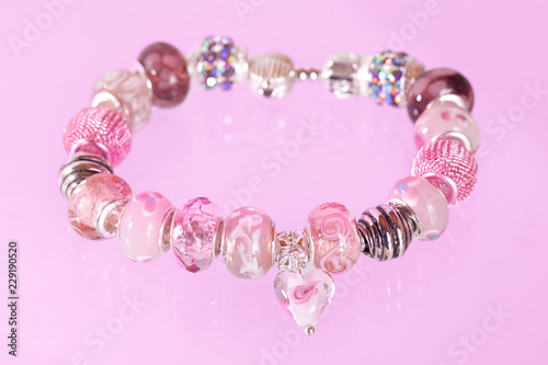 Pretty pink bracelet against pink background