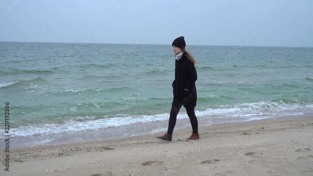 The girl walks on the beach. Shooting on the beach. The girl walks on the beach. Shooting on the beach.