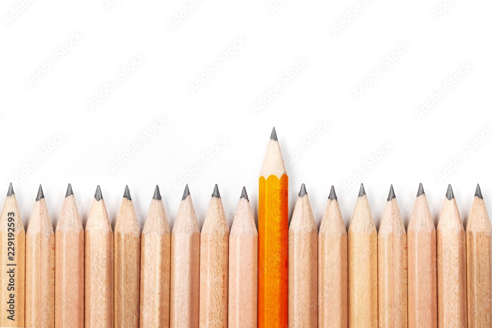 Orange pencil standing out from crowd of black pencils on white background. - obrazy, fototapety, plakaty 