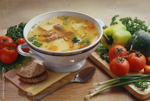 Суп с говядиной и пастой, на сервированном столе Beef and pasta soup on a served table