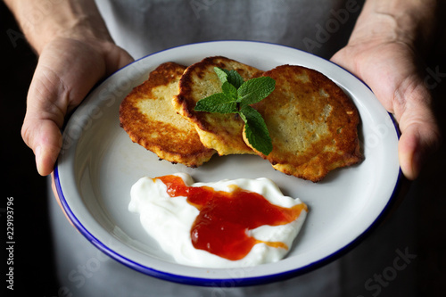 breakfast of yoghurt and jam pancakes close up.