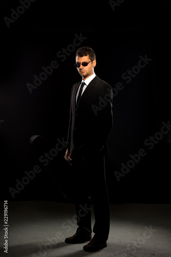 A serious man in a black suit. photo