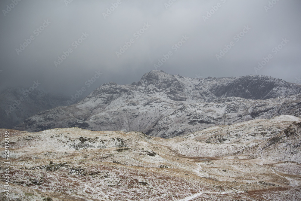 Winter in the Langdale valley, English Lake District with low cloud and light snow dusting the fells