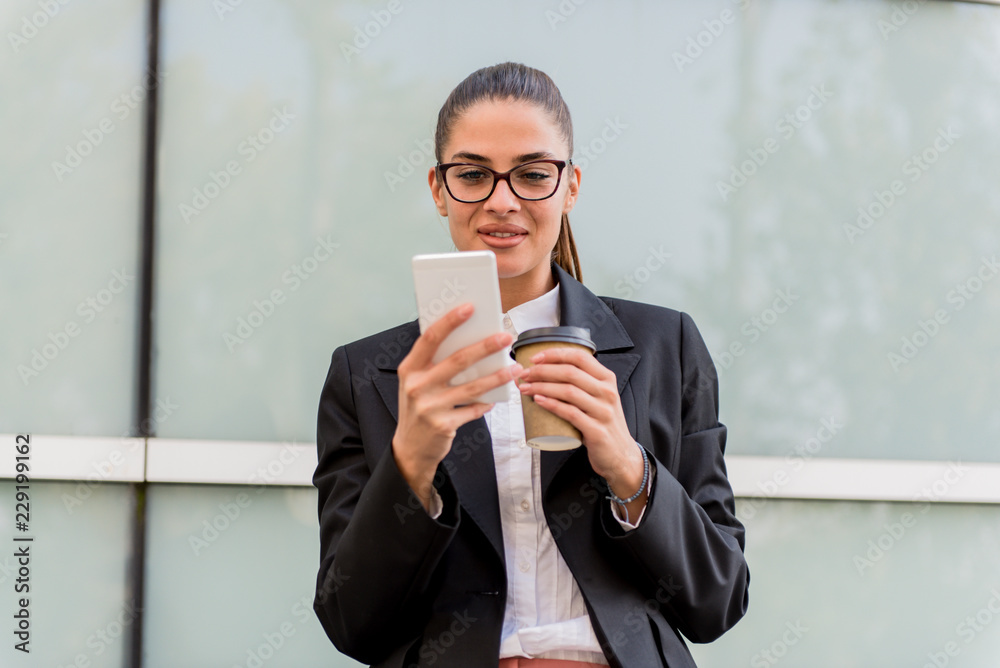 Caucasian businesswoman networking on smartphone at coffee break Caucasian businesswoman networking on smartphone at coffee break