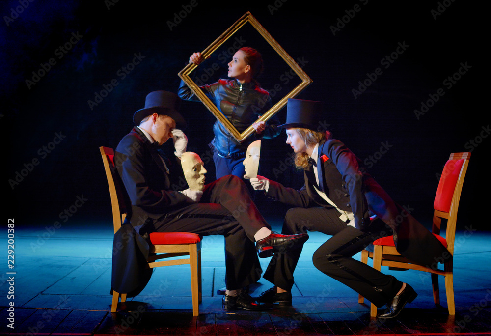 young actors in tuxedos holding a theatrical mask and picture frame - obrazy, fototapety, plakaty 