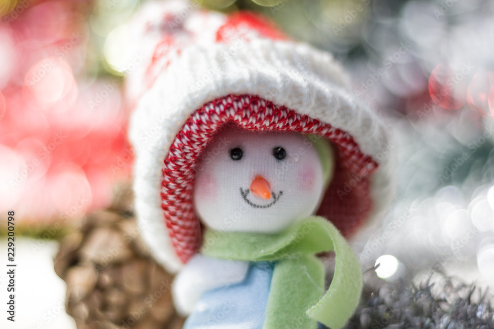 Obraz premium Christmas symbol - happy snowman in a red hat.