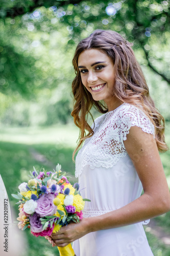 Wedding scene - bride with flower bouquet outdoor