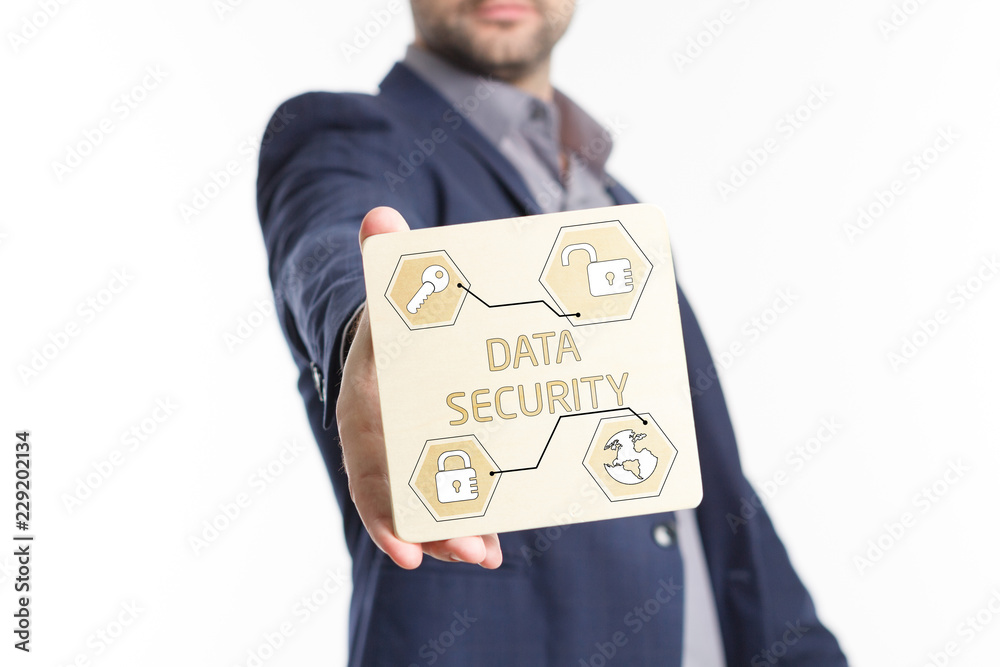 The concept of business, technology, the Internet and the network. Young businessman showing inscription: Data security The concept of business, technology, the Internet and the network. Young businessman showing inscription: Data security
