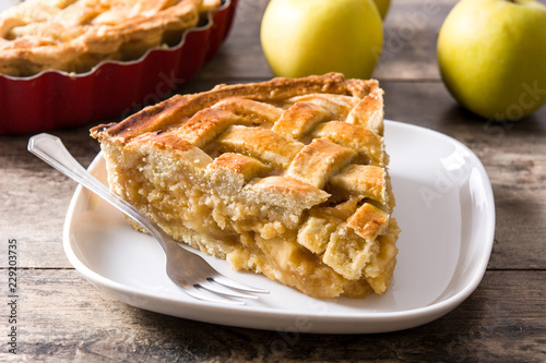 Homemade apple pie slice on wooden table