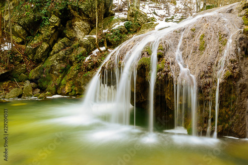 Waterfall Jur-Jur in winter  green moss and water  Crimea  Russia