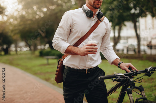 Man walking on street with his bicycle photo