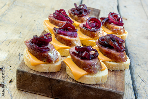 Croutons of bread with cheese sausage and caramelized onion photo