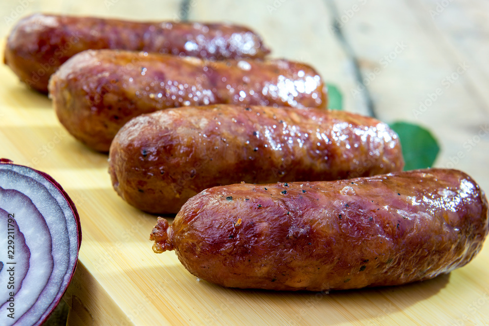 Grilled sausages on cutting board Grilled sausages on cutting board