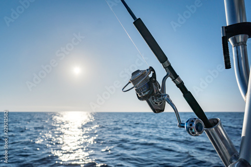 Closeup on fisherman rod on the ocean coast background