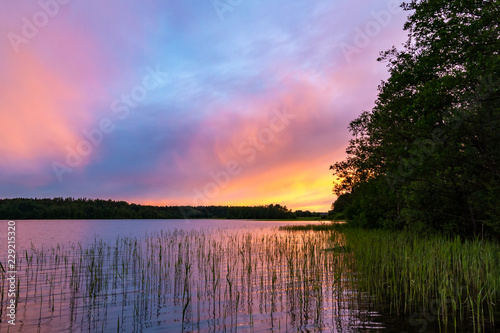 Reflected in the smooth water of the lake clouds at sunset. Colorful landscape  background blur