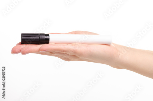 Black marker in hand on a white background. Isolation