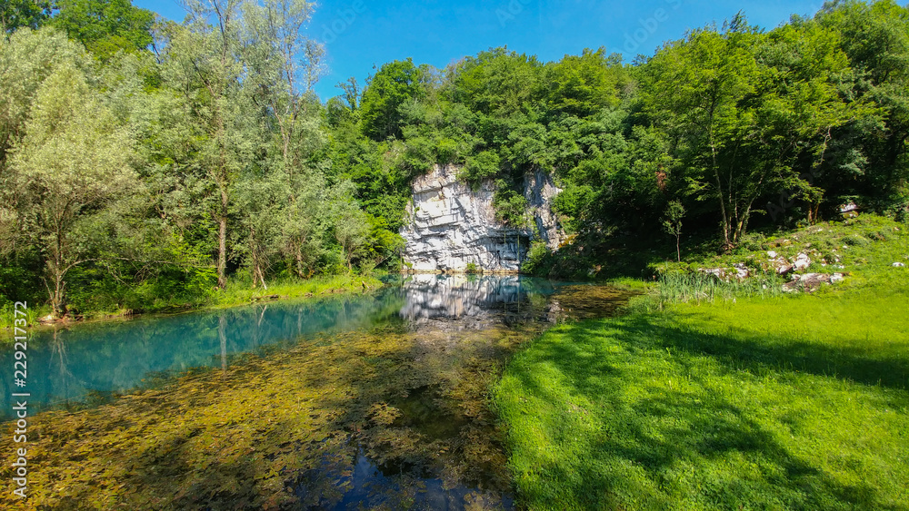 Krupa Spring (Izvir Krupa) in Bela Krajina, southern Slovenia, is a big karst spring below rock wall. It is protected as natural heritage and special habitat of water spices. Krupa Spring (Izvir Krupa) in Bela Krajina, southern Slovenia, is a big karst spring below rock wall. It is protected as natural heritage and special habitat of water spices.
