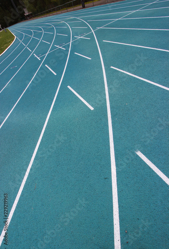Fototapeta Naklejka Na Ścianę i Meble -  running racetrack with white lines on blue ground