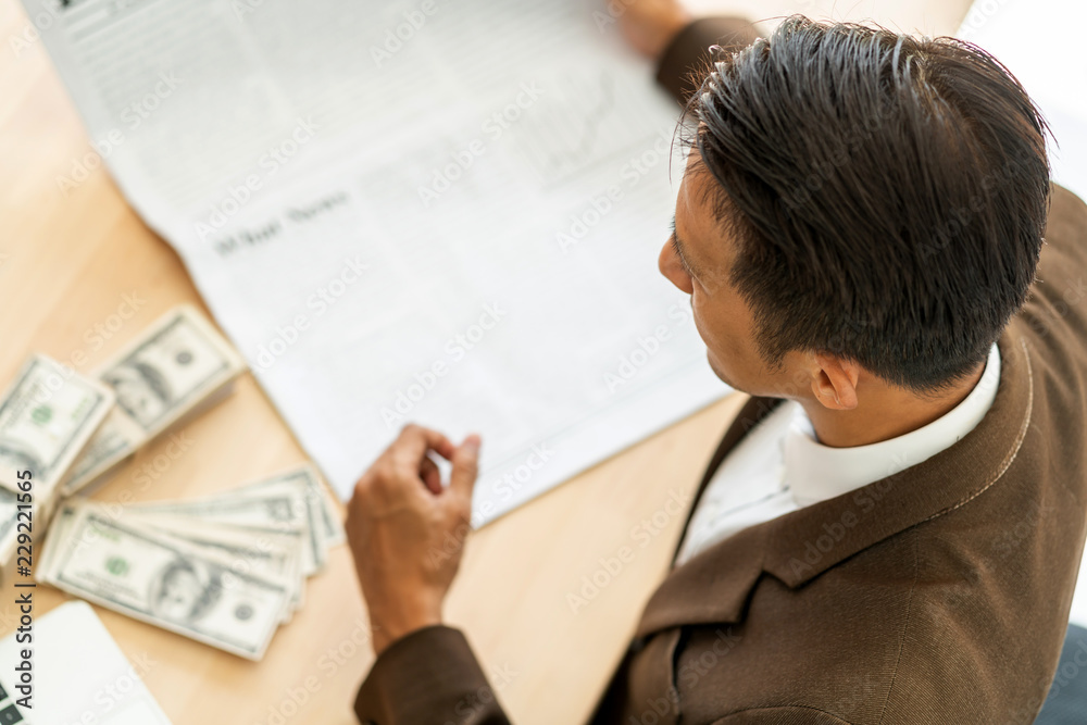 business asian man focus and thinking with money and project on table color tone image business asian man focus and thinking with money and project on table color tone image