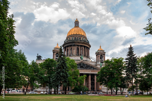 View of St. Isaac's Cathedral from the garden in a summer day against the backdrop of beautiful clouds, St. Petersburg, Russia
