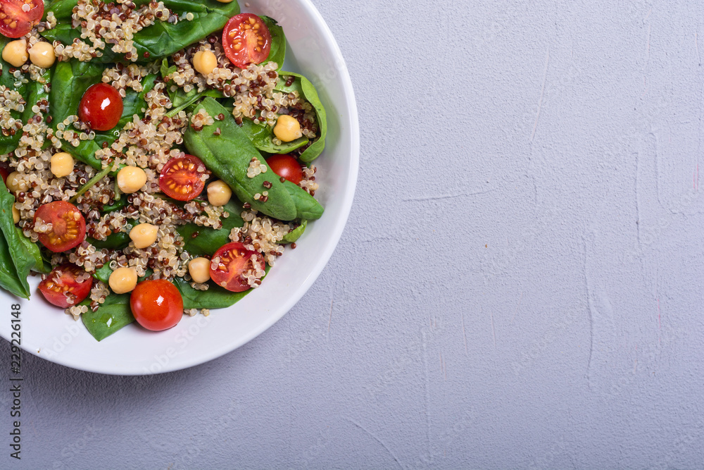 Spinach salad with quinoa , tomatoes and chickpea