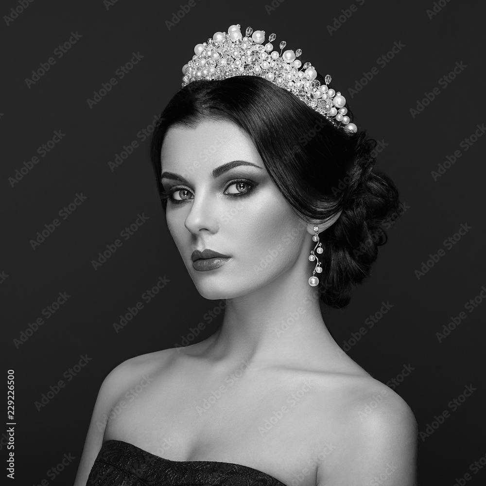 Fototapeta premium Fashion Portrait of Beautiful Woman with Tiara on head. Elegant Hairstyle. Perfect Make-Up and Jewelry. Black and White Photo
