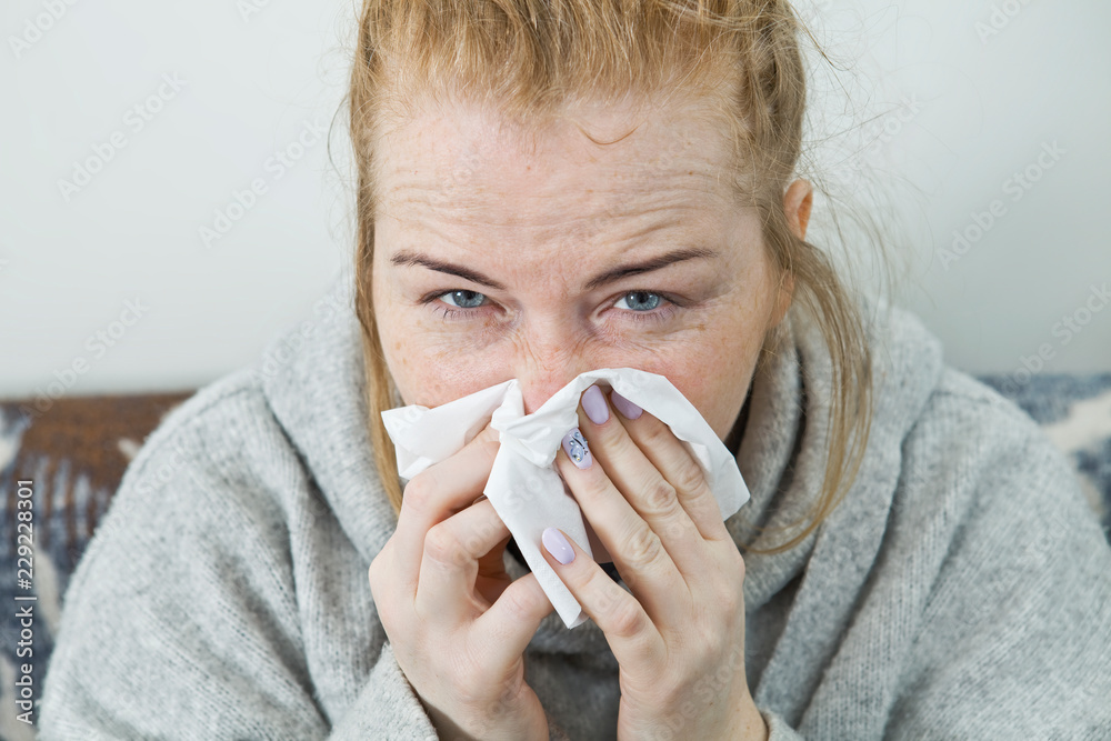 Young woman sick in bed wearing sweater. Illness Young woman sick in bed wearing sweater. Illness