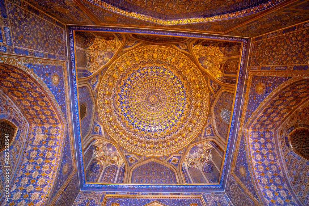 Blue interior with gold gild of Tile Karl Madrasa in The Registan, Samarkand, Uzbekistan