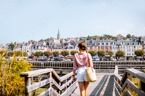 Woman enjoying great view on the beautiful riverside in Trouville city, famous french resort in Normandy