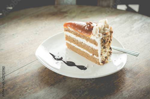 layer cake with coffee flavor and caramel syrup in cafe(vintafe color) photo