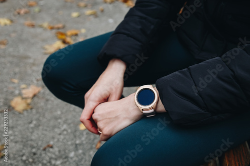 technology and people concept - close up of woman hands setting up and checking on her new digital smart watch