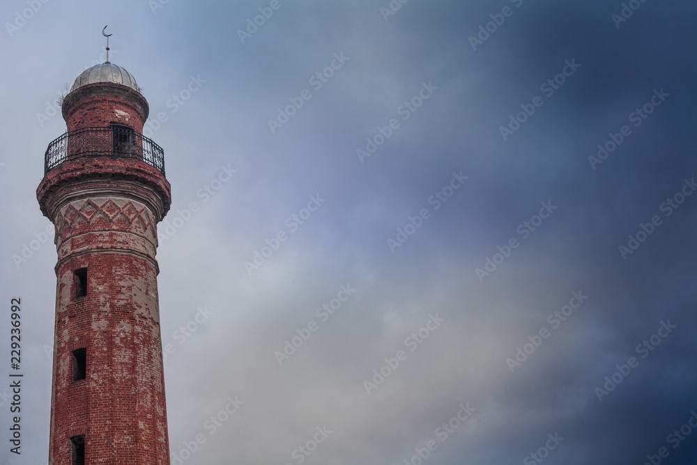 Old minaret against the sky